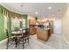 Bright kitchen with breakfast nook, center island, stainless steel appliances and tile floor at 4094 Sw 51St Ct, Ocala, FL 34474
