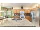 Bright kitchen with breakfast nook, stainless steel appliances, tile floor and granite countertops at 4094 Sw 51St Ct, Ocala, FL 34474
