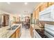 Kitchen showcasing granite countertops, wooden cabinets, and white appliances at 4094 Sw 51St Ct, Ocala, FL 34474