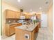 Spacious kitchen featuring an island, granite countertops, stainless steel appliances, and tile flooring at 4094 Sw 51St Ct, Ocala, FL 34474