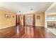 Inviting living room featuring hardwood floors, warm paint, and views into an adjacent living area at 4094 Sw 51St Ct, Ocala, FL 34474