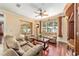 Comfortable living room with leather seating, hardwood floors, and a view into an enclosed patio at 4094 Sw 51St Ct, Ocala, FL 34474