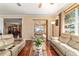 Bright living room with leather sofas and hardwood floors, open to the dining area through a doorway at 4094 Sw 51St Ct, Ocala, FL 34474