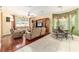 Comfortable living room with plush leather seating, a ceiling fan, and a large window at 4094 Sw 51St Ct, Ocala, FL 34474