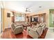 Cozy living room featuring comfortable seating, a large window, and a decorative floor lamp at 4094 Sw 51St Ct, Ocala, FL 34474