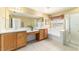 Main bathroom featuring double sinks, a soaking tub, and a walk-in shower at 4094 Sw 51St Ct, Ocala, FL 34474