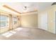 Spacious main bedroom showcasing tray ceilings, a ceiling fan, and neutral carpeting at 4094 Sw 51St Ct, Ocala, FL 34474