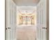 Spacious main bedroom showcasing tray ceilings, a ceiling fan, and three large windows at 4094 Sw 51St Ct, Ocala, FL 34474