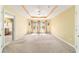 Spacious main bedroom showcasing tray ceilings, a ceiling fan, and three large windows at 4094 Sw 51St Ct, Ocala, FL 34474