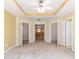 Spacious main bedroom showcasing tray ceilings, a ceiling fan, and neutral carpeting at 4094 Sw 51St Ct, Ocala, FL 34474