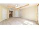 Spacious main bedroom showcasing tray ceilings, a ceiling fan, and neutral carpeting at 4094 Sw 51St Ct, Ocala, FL 34474