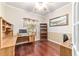 Home office with hardwood floors, built-in desk, and ample natural light at 4094 Sw 51St Ct, Ocala, FL 34474