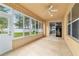 Bright sunroom with neutral colors, tile flooring, and exterior view at 4094 Sw 51St Ct, Ocala, FL 34474