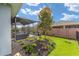 Landscaped backyard featuring a screened-in lanai and an arrangement of colorful flowerbeds at 4340 Nw 56Th Ct, Ocala, FL 34482