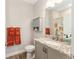 Cozy bathroom features gray cabinetry, granite countertops, and orange accent towels at 4340 Nw 56Th Ct, Ocala, FL 34482