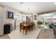 Cozy dining area features a wooden table, chandelier lighting and sliding glass doors to the patio at 4340 Nw 56Th Ct, Ocala, FL 34482