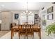 Bright dining room with wood table, chandelier, and large windows with blinds at 4340 Nw 56Th Ct, Ocala, FL 34482