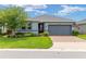 Charming single-story home with well-manicured lawn, brick driveway, and attached two-car garage at 4340 Nw 56Th Ct, Ocala, FL 34482