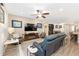 Comfortable living room with a large television, leather couches, and wood-look tile flooring at 4340 Nw 56Th Ct, Ocala, FL 34482