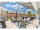 Screened-in lanai with comfortable seating, patio furniture, and views of the landscaped backyard at 4340 Nw 56Th Ct, Ocala, FL 34482
