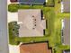 A top-down aerial view of the roof and landscaping surrounding this beautiful home at 4416 Homan Loop, The Villages, FL 32163