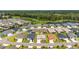 Aerial view showcasing the home's setting in a well-planned community with scenic ponds at 4416 Homan Loop, The Villages, FL 32163