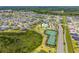 Stunning aerial view of a Primary-planned community with pool, tennis courts, lush landscaping, and beautiful single-Gathering homes at 4416 Homan Loop, The Villages, FL 32163