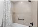 Modern bathroom featuring a tiled shower and grab bar for added safety at 4416 Homan Loop, The Villages, FL 32163