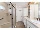 Bathroom featuring a glass enclosed shower, double sinks, and ample storage at 4416 Homan Loop, The Villages, FL 32163