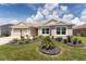 Lovely single-story home with landscaped front yard, bright windows, and an attached two-car garage at 4416 Homan Loop, The Villages, FL 32163