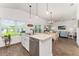 Open kitchen featuring stainless steel appliances and an island with bar seating and pendant lights at 4416 Homan Loop, The Villages, FL 32163