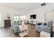 Bright living room with hardwood floors, ceiling fan, and comfortable seating at 4416 Homan Loop, The Villages, FL 32163