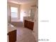 Bathroom with separate shower and tub, vanity with cabinets, and neutral tile at 4420 Sw 100Th St, Ocala, FL 34476