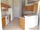 Functional kitchen featuring tile floors, plentiful cabinetry, and counter seating area at 4420 Sw 100Th St, Ocala, FL 34476