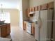 Bright kitchen with tile flooring, ample cabinet space, and appliances including a white refrigerator and range at 4420 Sw 100Th St, Ocala, FL 34476