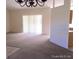 Open living space featuring carpeted floors and natural light from sliding glass doors at 4420 Sw 100Th St, Ocala, FL 34476