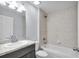 This bathroom features a vanity with a light gray cabinet and a shower over the tub at 4501 Sw 159Th Street Rd, Ocala, FL 34473