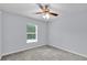 This bedroom features neutral walls, plush carpet, and a ceiling fan at 4501 Sw 159Th Street Rd, Ocala, FL 34473