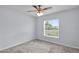 This bedroom features neutral walls, plush carpet, and a ceiling fan at 4501 Sw 159Th Street Rd, Ocala, FL 34473