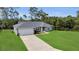 Attractive single-Gathering home with a well-kept lawn, attached garage, and a private, wooded backdrop at 4501 Sw 159Th Street Rd, Ocala, FL 34473