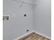 Bright laundry room with wood-look flooring and utility connections at 4501 Sw 159Th Street Rd, Ocala, FL 34473