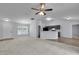 Open-concept living area featuring neutral walls, carpet, ceiling fan, breakfast bar and light wood floors at 4501 Sw 159Th Street Rd, Ocala, FL 34473