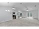 Spacious living room with carpet, fan, neutral walls, and sliding glass doors to the exterior at 4501 Sw 159Th Street Rd, Ocala, FL 34473