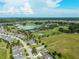 This aerial perspective shows a community near a lush golf course and serene lake at 5093 Nw 35Th Lane Rd, Ocala, FL 34482