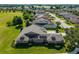 Aerial view of home featuring solar panels, landscaping, and a golf course view at 5093 Nw 35Th Lane Rd, Ocala, FL 34482