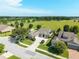 Aerial view of home with lush green landscaping, a circular driveway, and golf course views at 5093 Nw 35Th Lane Rd, Ocala, FL 34482