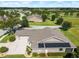 Aerial view shows the roof with solar panels, a driveway and a lush green lawn at 5093 Nw 35Th Lane Rd, Ocala, FL 34482