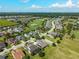 A stunning aerial view showcases a community near a golf course, under a blue sky at 5093 Nw 35Th Lane Rd, Ocala, FL 34482