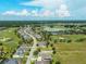 A captivating aerial view features a community with a golf course, lake, and stunning landscaping at 5093 Nw 35Th Lane Rd, Ocala, FL 34482