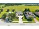 Aerial view of a home with well-manicured landscaping, circular driveway, and golf course view at 5093 Nw 35Th Lane Rd, Ocala, FL 34482